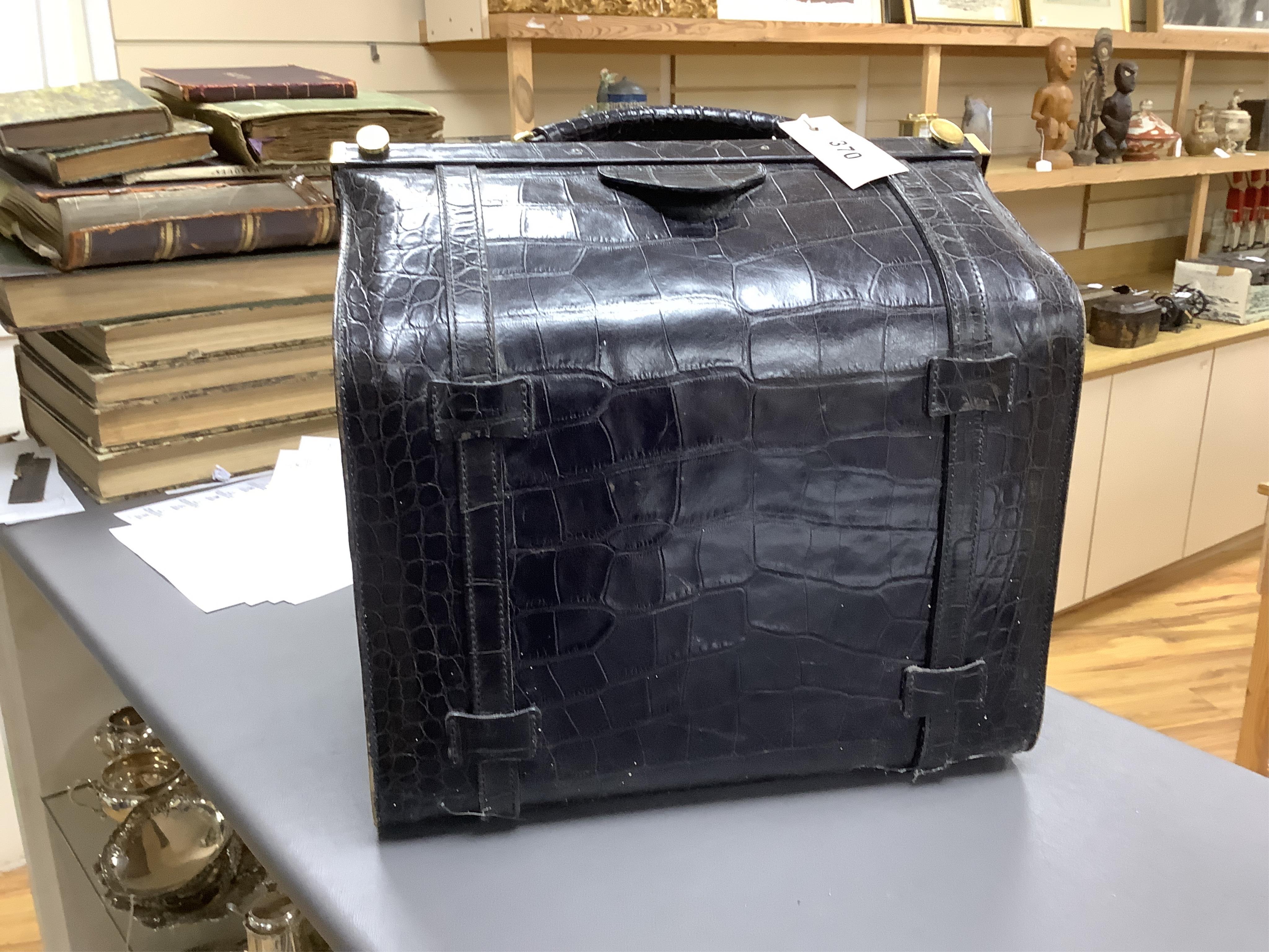 A 1940’s ladies crocodile skin Gladstone bag with gilt metal hardware, 34cm wide
